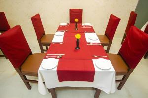 a table with a red and white table cloth at Hotel Sweet Place in Dhaka