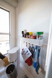 a bathroom with a shelf with utensils on the wall at Rosi's Ferienwohnung im Haus Sieglinde in Prien am Chiemsee +30 photos