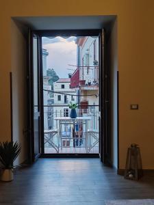 an open door to a balcony with a potted plant at Lissy Casa Vacanze in Lamezia Terme +7 photos