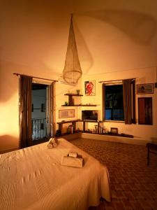 a bedroom with a bed with two towels on it at allacasett in Favignana