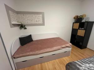 a small bedroom with a small bed in it at Harmony Apartman in Dunajská Streda