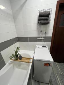 a small bathroom with a tub and a sink at Harmony Apartman in Dunajská Streda +6 photos