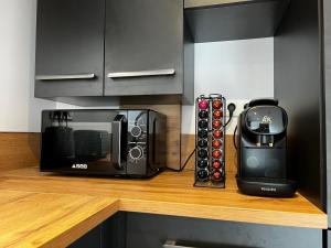 a microwave sitting on a counter next to a coffee maker at Gîte de Charme in Saint-Avit-de-Tardes