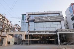 a building in the middle of a city at Hotel Krishnam Vrindavan in Vrindāvan