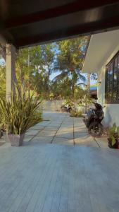 a patio with a motorcycle parked next to a house at Foavahi Shark View Inn in Fuvahmulah
