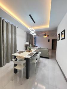 a dining room with a table and chairs and a couch at Foavahi Shark View Inn in Fuvahmulah