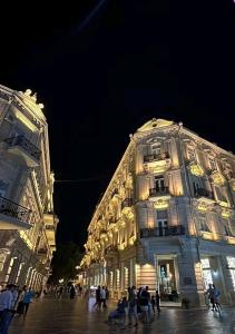 a group of people walking in front of a building at Baku City Inn Boutique Nizami Hotel in Baku