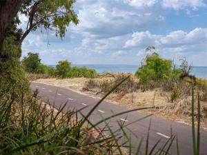 an empty road with the ocean in the background at 1CapeView beachfront Geographe Bay in Broadwater +20 photos