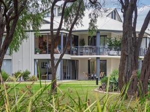 an exterior view of a house with trees at 1CapeView beachfront Geographe Bay in Broadwater