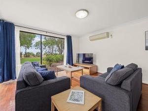 a living room with two couches and a tv at 1CapeView beachfront Geographe Bay in Broadwater
