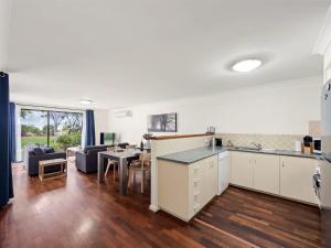 a kitchen and living room with a table and a couch at 1CapeView beachfront Geographe Bay in Broadwater