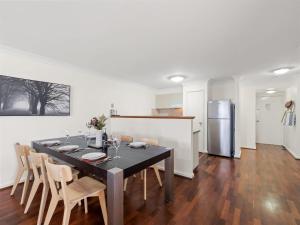 a kitchen and dining room with a table and chairs at 1CapeView beachfront Geographe Bay in Broadwater