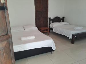 a room with two beds and a table at Casa Samuel in Honda