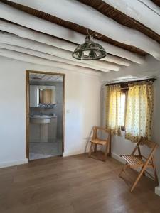 a room with a mirror and a chair and a sink at Casa Jardin in Lobras +32 photos