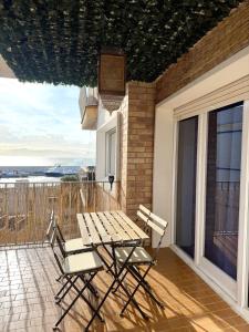 a patio with a table and chairs on a balcony at Ocean Breath Home in L'Ametlla de Mar