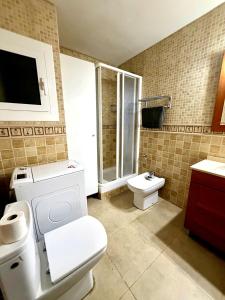a bathroom with a white toilet and a sink at Ocean Breath Home in L'Ametlla de Mar +24 photos