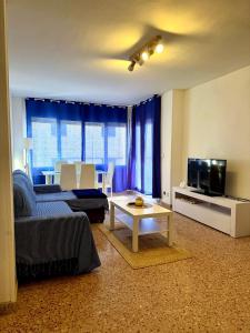 a living room with a couch and a tv at Ocean Breath Home in L'Ametlla de Mar