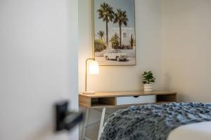 a bedroom with a bed and a desk with a car on the wall at Mooloolaba Canal Retreat with Pool Sleeps 12 in Mooloolaba
