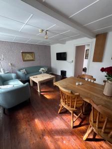 a living room with a table and a couch at Skelby Præstegård lej 2 in Gedser
