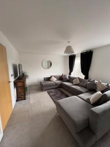 a living room with a couch and a tv at Whistle Stop Terrace in Barnby Dun