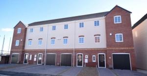 a large brick building with its doors open at Whistle Stop Terrace in Barnby Dun