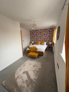 a bedroom with a bed and a couch in it at Whistle Stop Terrace in Barnby Dun