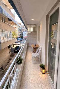 a balcony with a table and a chair on a building at Soydan World Travel in Antalya