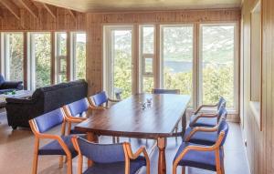 a dining room with a wooden table and chairs at Konstali Gard in Flekkefjord