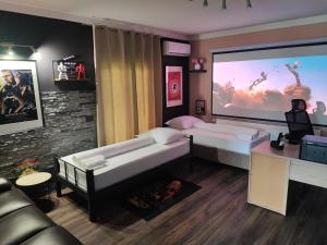 a room with two beds and a large screen at Zagora Hills Premium Apartman in Krapina +45 photos