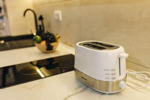 a toaster sitting on a counter in a kitchen at Apartman Prime - free parking in Belgrade
