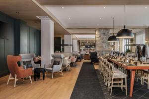 a restaurant with tables and chairs and a bar at Residence Inn by Marriott Bromont in Bromont