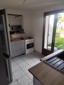 a kitchen with a stove and a counter top at Tableaux in Château-Renault