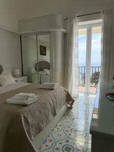 a bedroom with a bed and a large mirror at Capri Suite Dreams in Capri