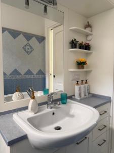a bathroom with a white sink and a mirror at Capri Suite Dreams in Capri