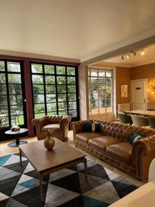 a living room with a couch and a table at Erawan Boutique Hôtel in Évreux