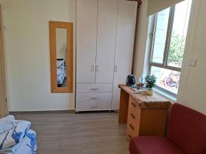 a bedroom with a bed and a dresser and a mirror at The Pearl in Sha‘alvim