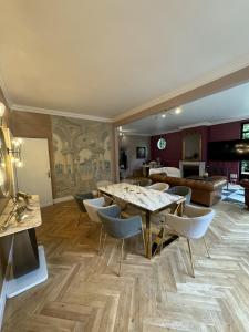 a living room with a table and chairs at Erawan Boutique Hôtel in Évreux +45 photos