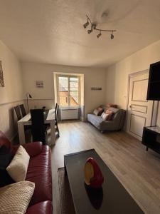 a living room with a couch and a table at Riquewihr in Riquewihr