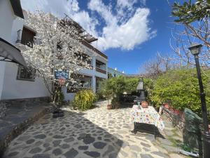 a patio with a table and a street light and a building at Casa Jardin in Lobras