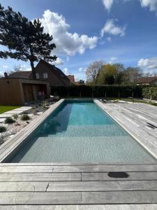 a swimming pool in a yard with a house at Executive Villa with pool in Londerzeel