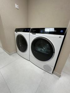 a washing machine is sitting in a room at Fully Equipped Guest House Košice-Barca in Košice