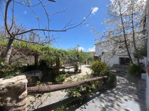 a garden with trees and a pathway at El Huerto de Lobras in Lobras