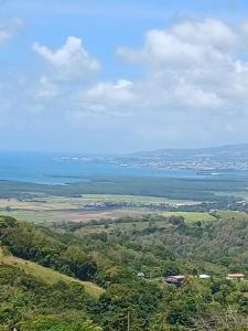a view of the ocean from the top of a hill at Santa Marta in Rivière-Pilote