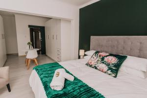 a bedroom with a bed with a towel on it at Seek First B&B in Pretoria
