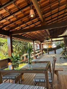 a patio with a table and chairs on a deck at Casa Au Clair de Lune Terê in Teresópolis