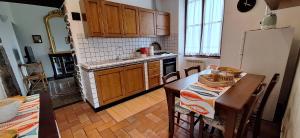 a kitchen with a table and a refrigerator at Casa del contadino in Rapallo