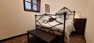 a bedroom with a bed with a wrought iron headboard at Casa del contadino in Rapallo