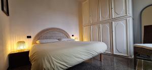 a bedroom with a white bed with a headboard at Casa del contadino in Rapallo