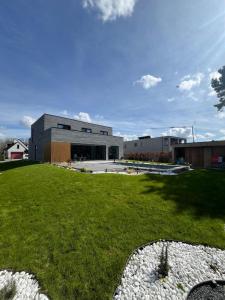 a view of a building with a grass yard at Executive Villa with pool in Londerzeel