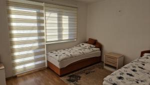 a small bedroom with two beds and a window at Villa Oaza Vilenjak in Visoko +11 photos